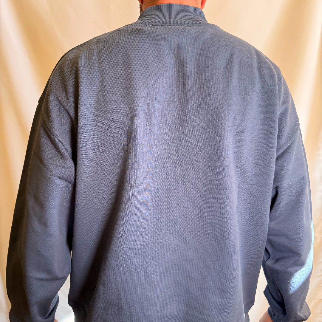 IRBN mock neck sweatshirt in Blue Indigo — back view showing oversized fit and ribbed mock neck, worn in XXL
