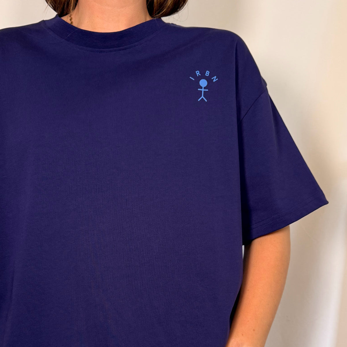 Detail shot of boxy oversized navy tshirt with blue logo. cotton