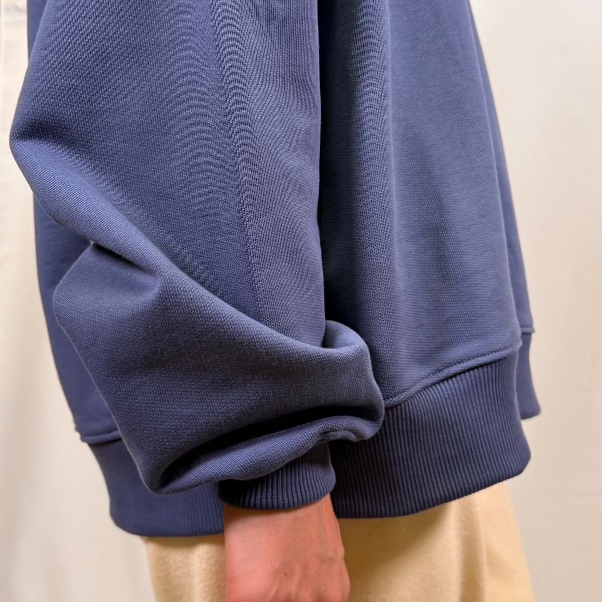 Close-up of ribbed cuff detail on IRBN mock neck sweatshirt in Blue Indigo, 400gsm GOTS-certified organic cotton