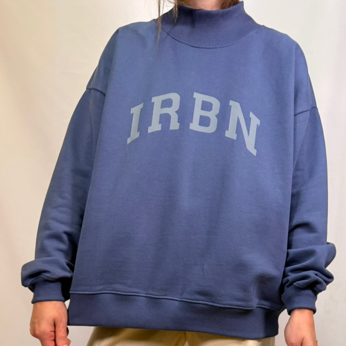 IRBN mock neck sweatshirt in Blue Indigo, full front view showing IRBN arched print and ribbed hem band