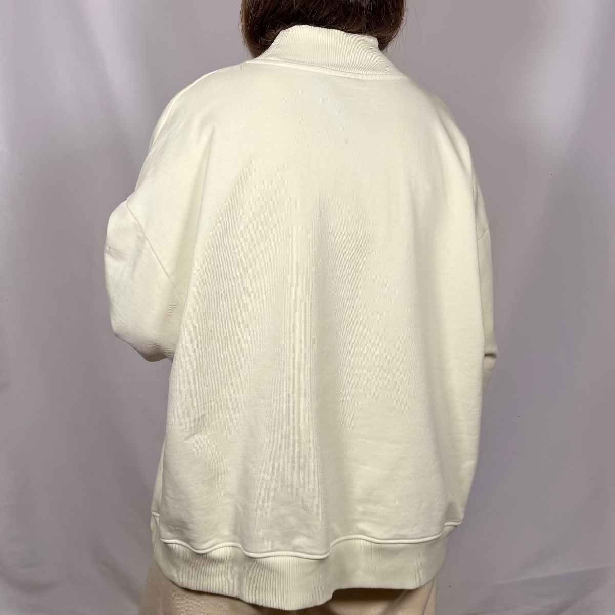 IRBN mock neck sweatshirt in Cannoli Cream, back view showing clean finish and ribbed hem band
