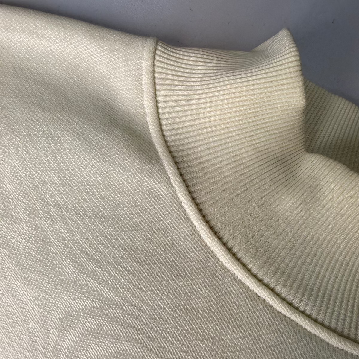 Close-up of IRBN Cannoli Cream Mock Neck and cuff, GOTS-certified organic cotton made in Portugal