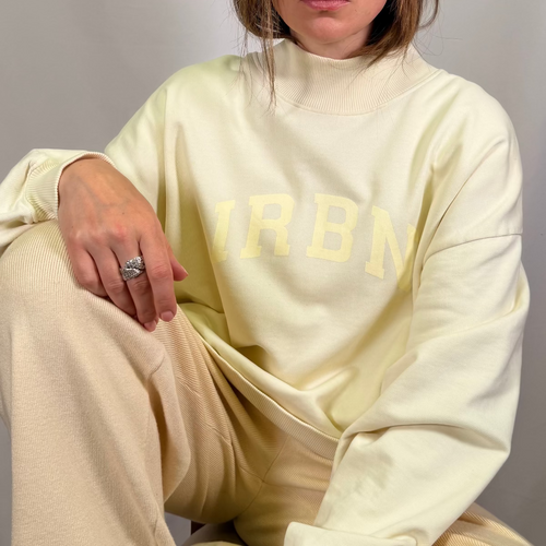 IRBN mock neck sweatshirt in Cannoli Cream, close-up of IRBN arched chest print, 400gsm organic cotton