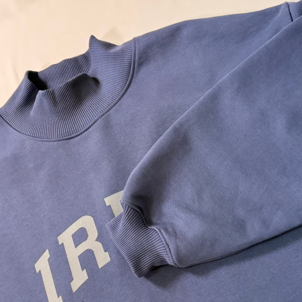Close-up of IRBN Indigo Blue Mock Neck and cuff, GOTS-certified organic cotton made in Portugal