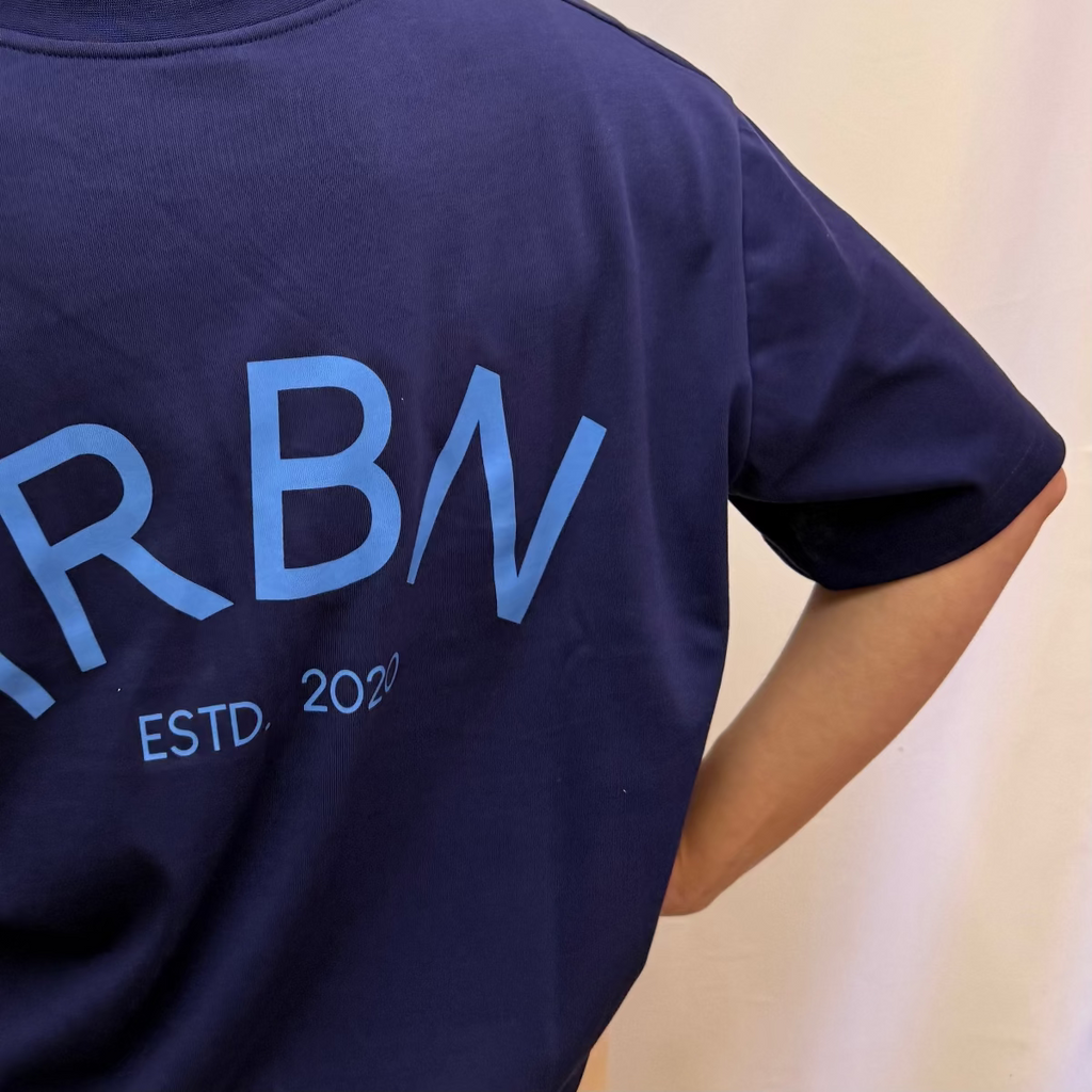 IRBN boxy t-shirt in Navy, back view showing IRBN ESTD. 2020 arched print in blue, 250gsm organic cotton