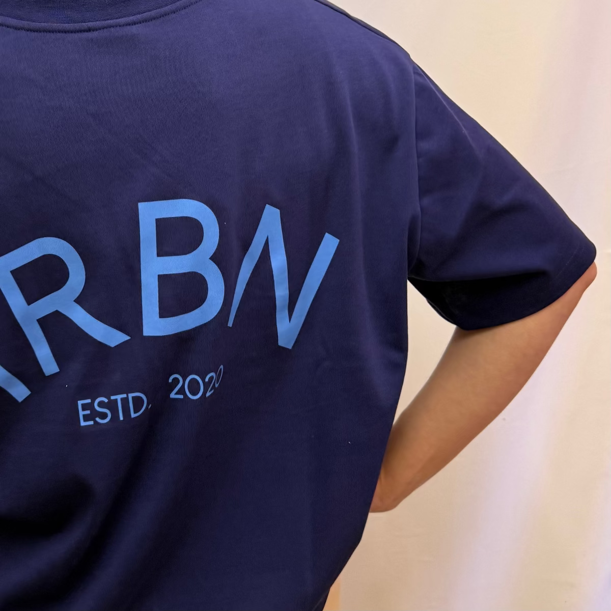 IRBN boxy t-shirt in Navy, back view showing IRBN ESTD. 2020 arched print in blue, 250gsm organic cotton