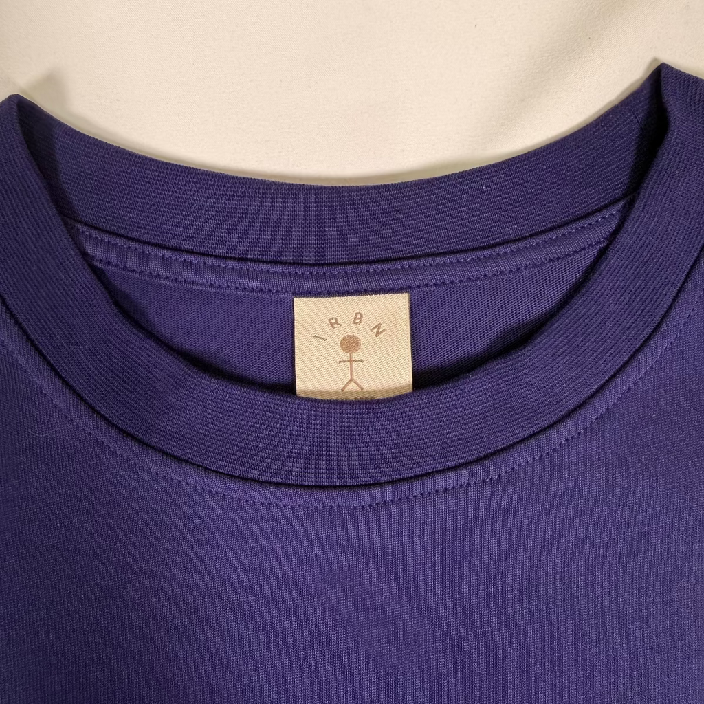 Close-up of woven IRBN neck label on Navy boxy t-shirt, GOTS-certified organic cotton made in Portugal
